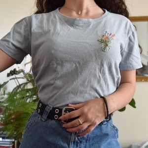 Simple baby blue tee with an embroidered bundle of wildflowers